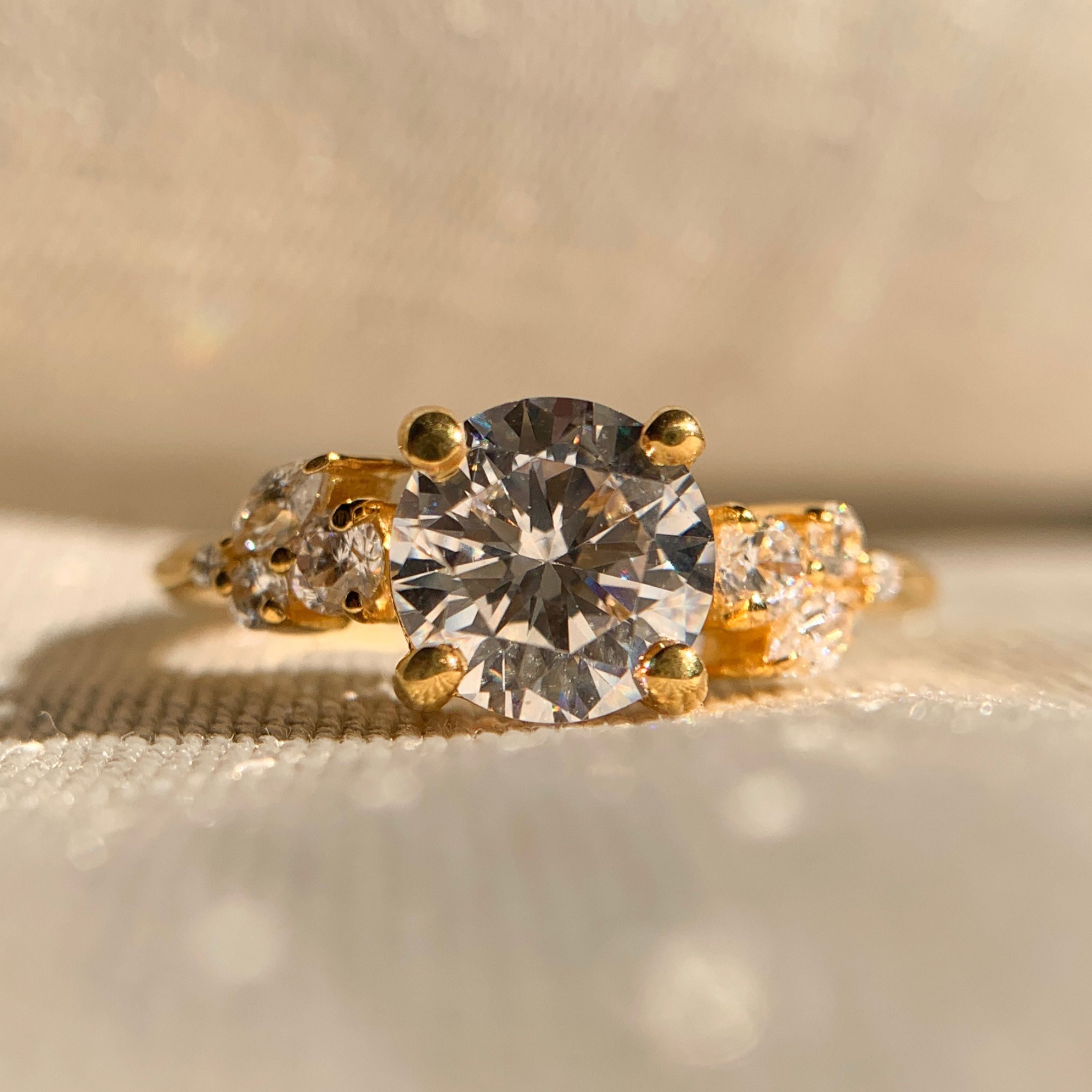 Elegant round diamond engagement ring with sparkling side stones in white gold setting